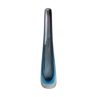 Tall and slim studio glass vase. Tall, slender vase in a sommerso style of purple interior framed in a brilliant turquoise and finished with a clear glass base. The vase evokes an image of a large drop of water. Measures 60mm in diameter at base and 32mm across the top with opening at 13mm. Weight 1325 grams. Collect from store only. Main photo of vase seen from an eye level angle. The water droplet shape is clearly visible.