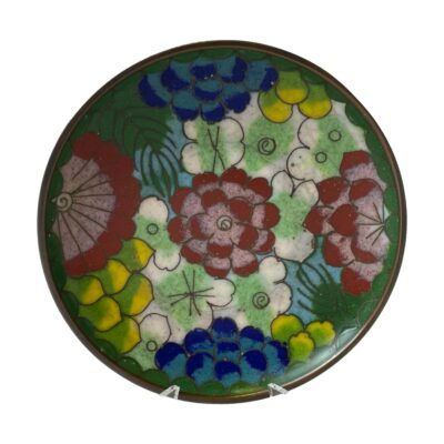 Antique Chinese cloissoné dish. Small late 19th century cloisonné dish with a pretty multi coloured floral theme to the centre. Airforce blue and green to the base. A few small manufacturer dips in the enamel. Measures 80mm in diameter at top and 45mm at the base. Main photo of dish displayed upright on a stand (the front prongs of the stand are just visible at the bottom). The 3 red larger flowers are shown in a left to right line and larger blue flowers at top and bottom. The smaller green flowers and yellow flower buds are scattered in the background.