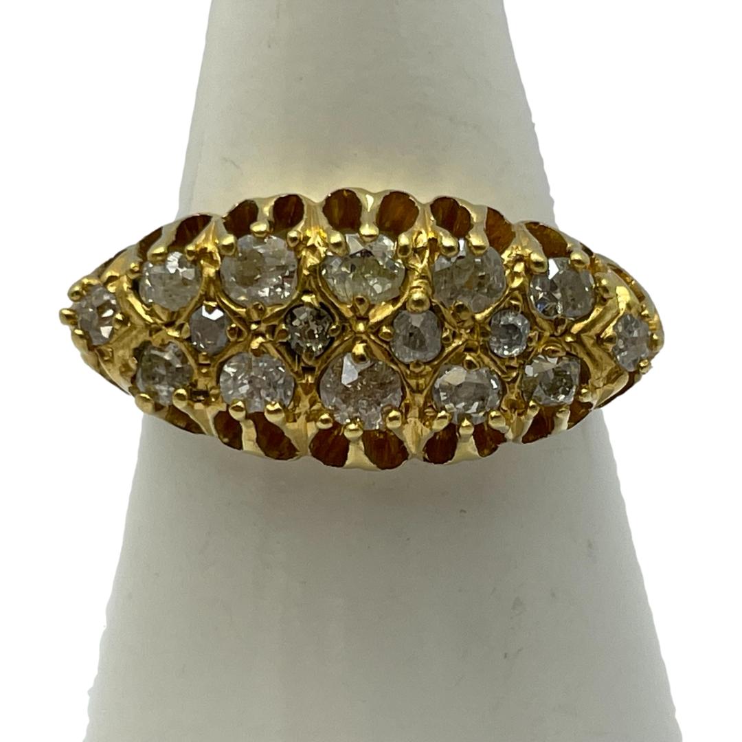 18 karat gold and diamond ring from the Art Deco era. Unusual wide gallery setting to house the 16 sparkling old brilliant cut diamonds. Hallmarked 18 on inside band with approximately 1.5 carats in diamonds. Ring size P / 7.75. Weight 4.9grams. Main photo of ring on a cone shaped stand and seen with ring front facing forward. The width of the ring overhangs the cone stand showing the wide eye shaped setting for the diamonds.