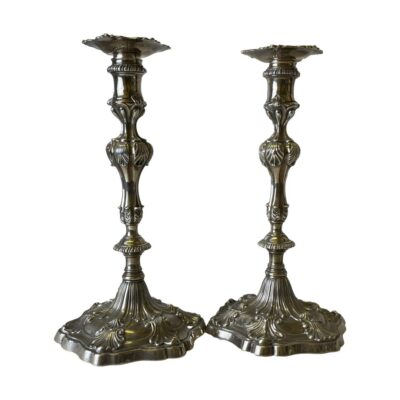 George III sterling silver candlesticks. Very fine pair of George III sterling silver candlesticks with scallop detail throughout. Assayed in London by silversmith Ebenezer Coker c1766. Full hallmark to the base and short hallmarks to neck of candlesticks and to the inside neck of the sconces. Both candlesticks are engraved CEM and have an engraved bird with oak branch & acorn to the top of sconces and lower area of the sticks. Each stick measures 275mm tall and 150mm in diameter at base. Candle slot is 22mm. Weight 47 Troy ounce. Recommend collection from store only. Main photo showing both candlesticks side by side from an eye level. The extensive decorative detail is