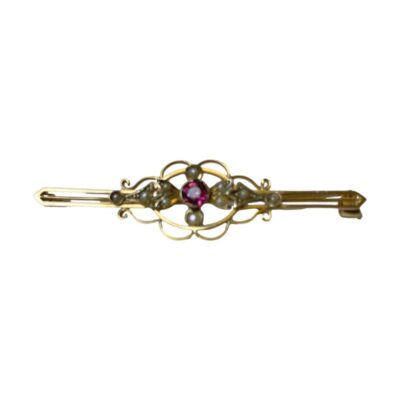 Victorian brooch with a central almadine garnet. Pretty Victorian 9 karat gold brooch with a beautiful almadine garnet to the centre. Intricate frame work around the garnet houses seed pearls - a combination favourite of the Victorians! Hallmarked 9ct to the back. Main photo of brooch shown horizontally across and forward facing. The almadine garnet sparkles pink in the centre.