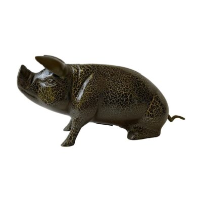 Heavy piggy bank in metal. Cast metal pig money box in gold and black crackle glaze effect and reddish brown to the base. Different glaze effect on each side. Original rubber stopper fits tight. Main photo of the pig shown from a side angle with the pigs head to the left. The pig is seated and snout is raised upward.