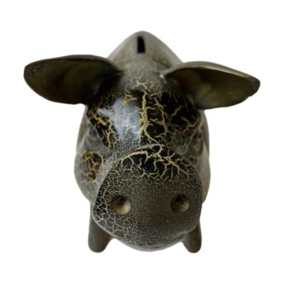 Heavy piggy bank in metal. Cast metal pig money box in gold and black crackle glaze effect and reddish brown to the base. Different glaze effect on each side. Original rubber stopper fits tight. Close up photo of the pig seen from the front straight on. The snout is in the centre foreground and the pig is looking straight at the camera!