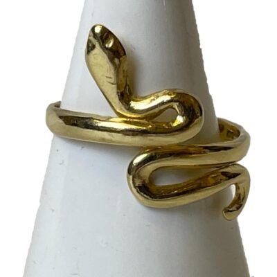 14 karat gold snake ring. Vintage wrap around style snake ring in 14 karat gold. It can be slightly adjusted as the band is not fixed. Lovely when worn with tail and head in opposing edges on the finger. Ring size M / 6. Weight 3.5gms. Main photo of ring on a cone shaped stand with the snakes head pointing towards the top left and tip of tail just visible to the bottom right. The ring can of course be worn the other way round!