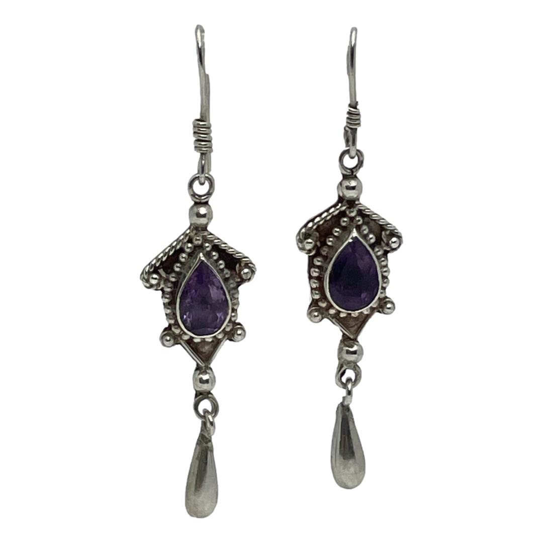 Main photo of earrings seen hanging with earring on right slightly higher up than other. The earrings are shown forward facing.