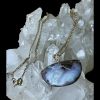 Main photo of boulder opal &diamond necklace displayed on top of a rock of natural quartz crystal. The pendant is to the lower right with the front on view. This is a lovely natural opal stone set in pendant form with a diamond in the bail. The gold chain has been draped over the crystal.