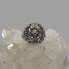 Main photo of adjustable silver marcasite ring displayed on top of a rock of natural quartz crystal with the ring front forward facing. The ring has a minimalist design of a squarish front with different shapes within.