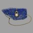 Main photo of gold pearl pendant &chain with the pendant hanging off a side of natural lapis lazuli rock and the chain laid across the top of the rock and extended out from the left and laid in a circular form around the stone. The gold setting for the pearl is on a circular design which has 2 short arms, one above one below like a piece of string laid with one circle loop and the end of the string laid above it. The ends of the gold 'string' acts as the bail for the chain - very neat!