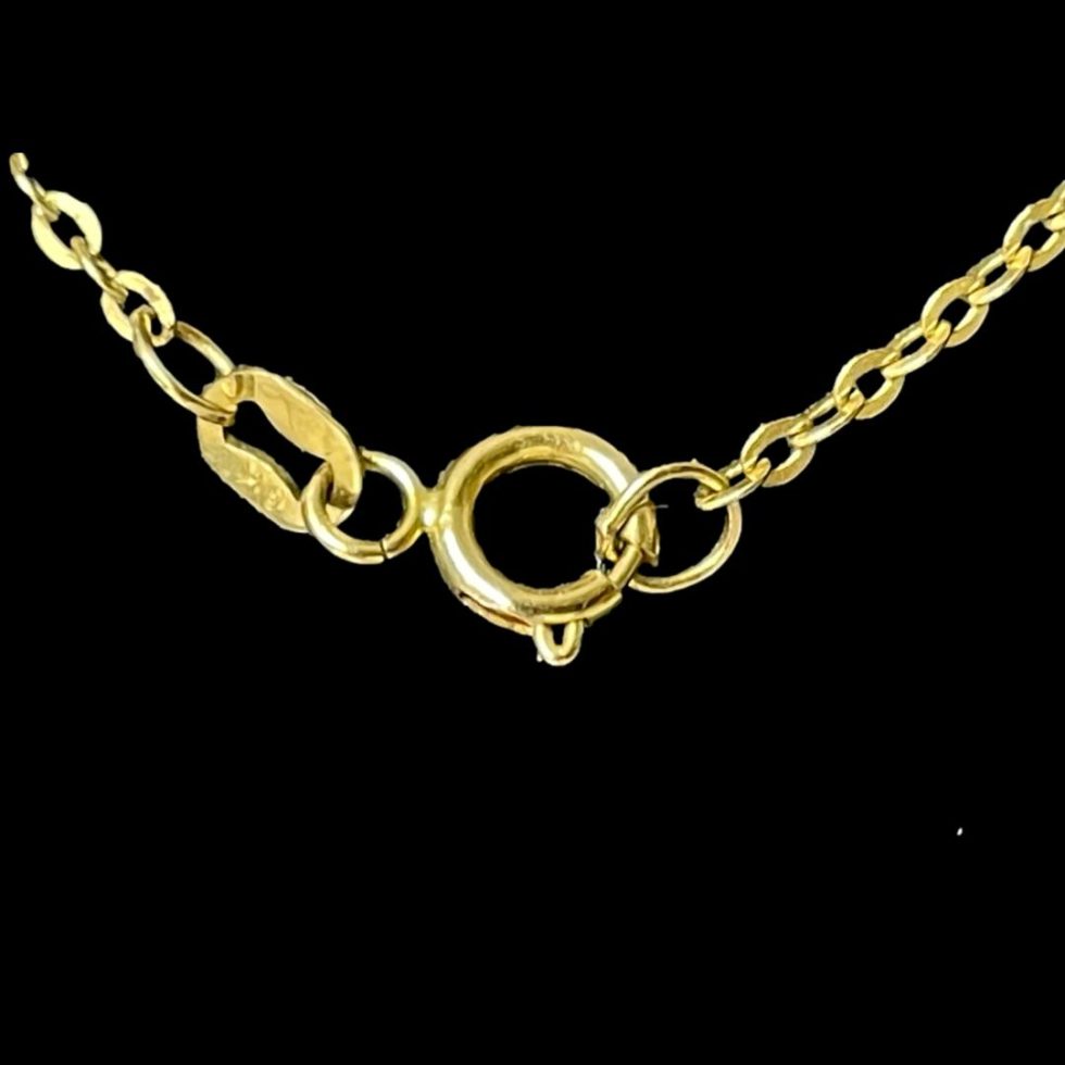 A close up of the hallmark on the gold disc chain necklace