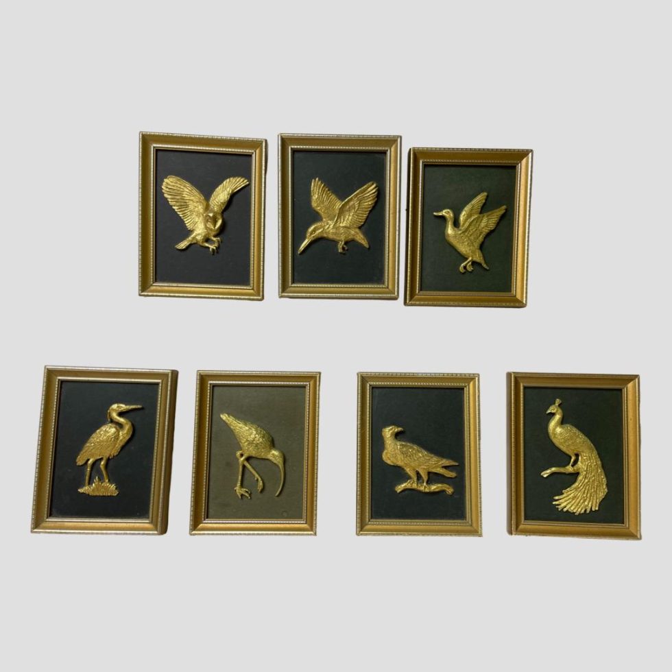 Main photo of framed set of gilt birds displayed against a light grey background. On the top row there are 3 pictures from L to R owl, kingfisher and duck and lower row has 4 from L to R egret, curlew, eagle and peacock. These are miniature gilt framed pictures with each one having identical frames. The birds are all in gilt and only the background for the curlew appears to be an olive green and not black like the others. These are fabulous pictures to enhance home deco or for bird lovers .