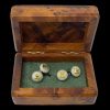 Main photo of sterling silver peridot cufflinks displayed inside their walnut effect wooden box. Both ends of the cufflinks are identical being circular, and textured silver with square cut peridot to the centre surrounded by a gilt silver frame.