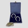 Main photo of both lucky sterling silver horseshoes displayed inside their original fitted case and shown the correct way up which is open end down to allow the luck to flow. The box is being held propped up by a small rock of gold ore lapis on the left.