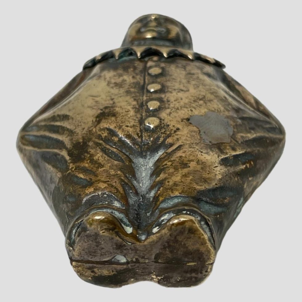 Clown vesta laid flat and seen with the base of feet in the foreground.