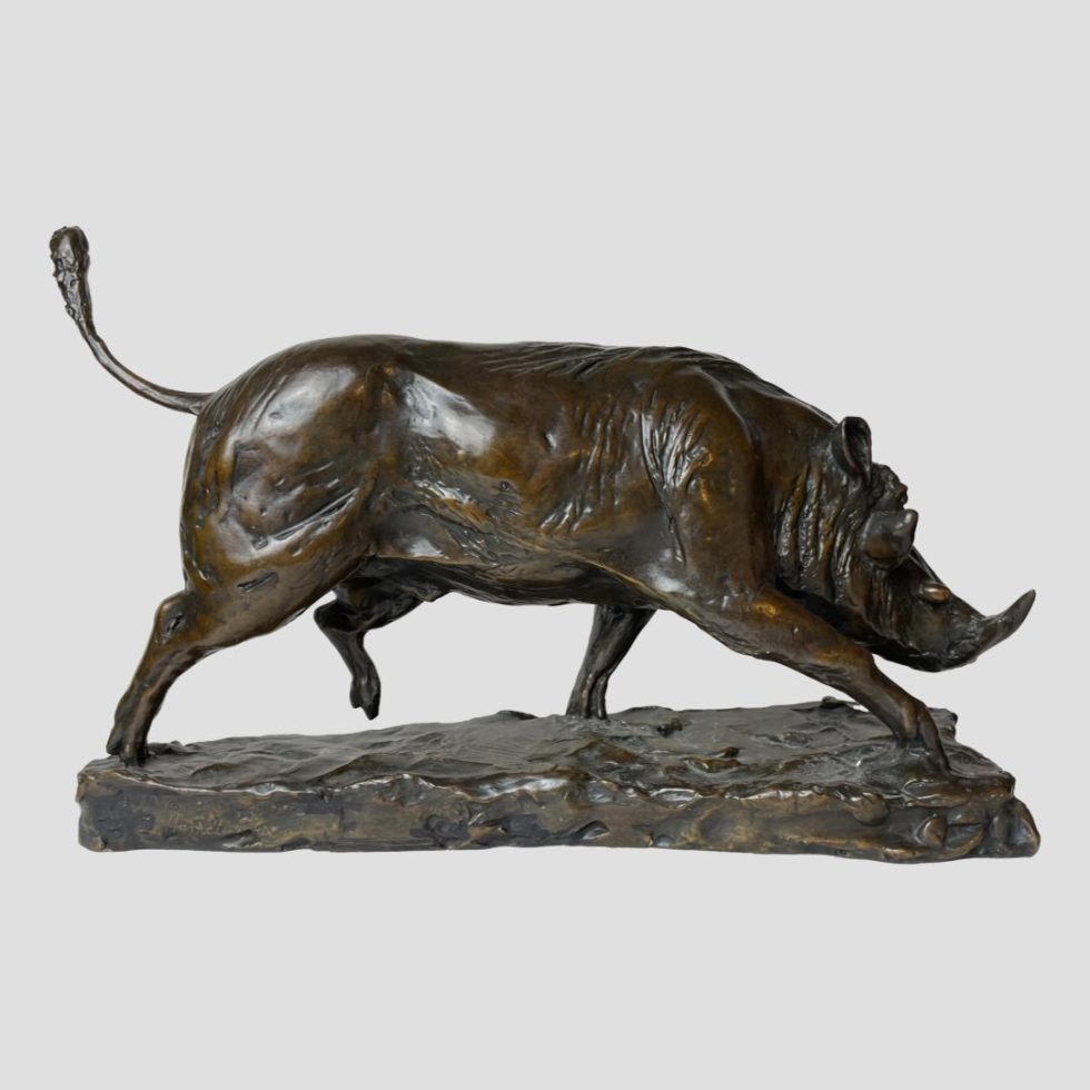 Photo of the wild boar bronze from a profile with the head facing right and tail curved upward towards top left corner.