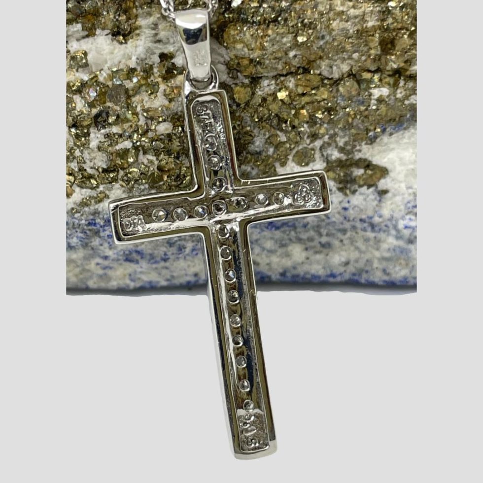 Photo of the back of the cross of gold diamond cross and chain showing hallmarks at end of each extremity. Most visible ones being 375 for 9 karat gold on the upper arm and DIA on the left.