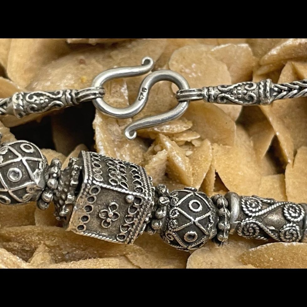 Close up of the main front beads and the clasp area of the vintage Rajasthani silver necklace. The 925 hallmark on the S hook is visible.