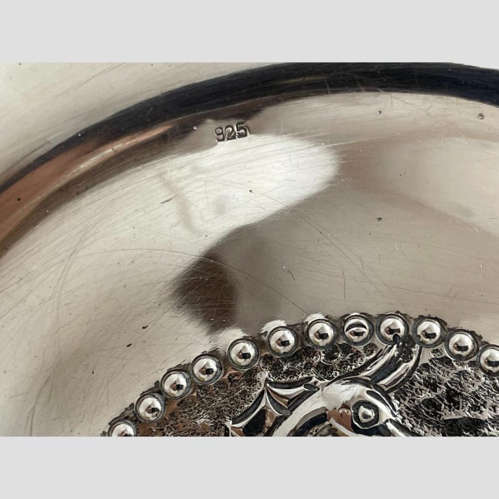 Close up photo of the 925 hallmark on the outer edge of sterling silver seahorse dish interior.