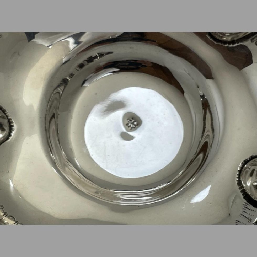 Close up photo of the hallmark to the dip inside the mid-century Greek silver bowl.
