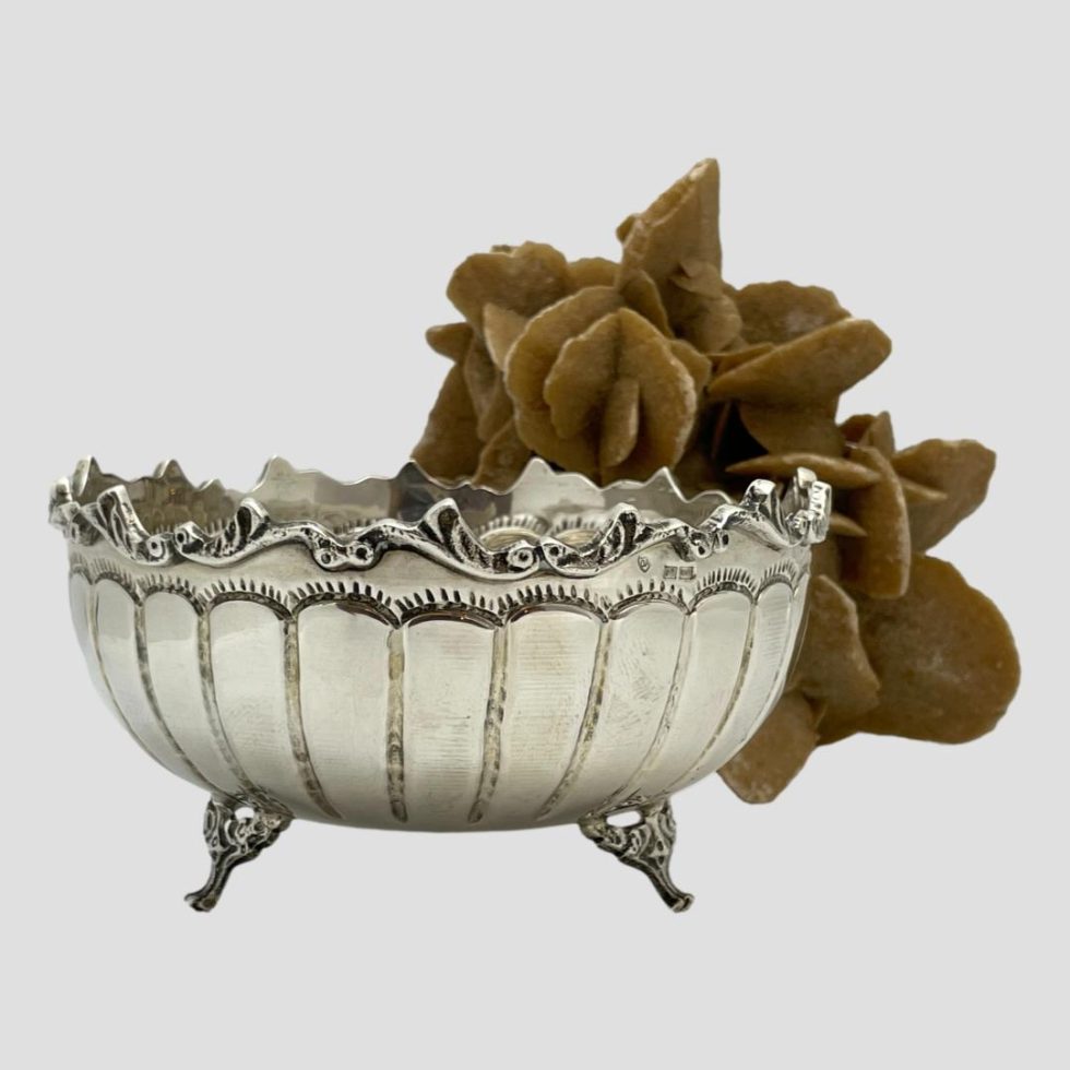 Close up of the bowl with starfish removed and just the desert rose to the back right. The segmented sections on the side is shown clearly with 2 of the 3 tripod feet in the foreground.