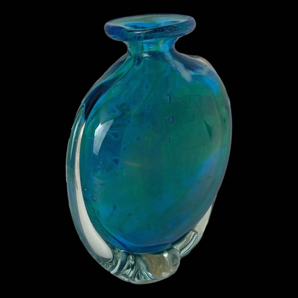 Photo of unsigned Mdina glass vase seen at a diagonal angle with one flat side facing to the bottom right corner.
