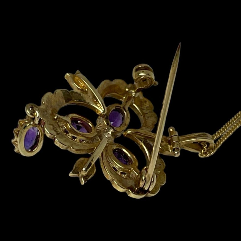 Photo of pendant/brooch and chain seen face down showing the pin open.