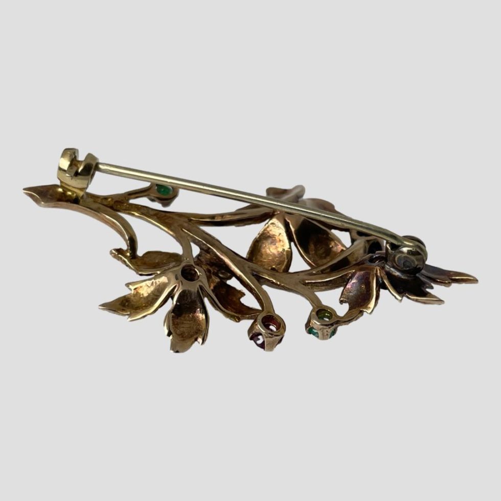 Photo of the back of brooch shown with pin closed. The brooch front is face down.