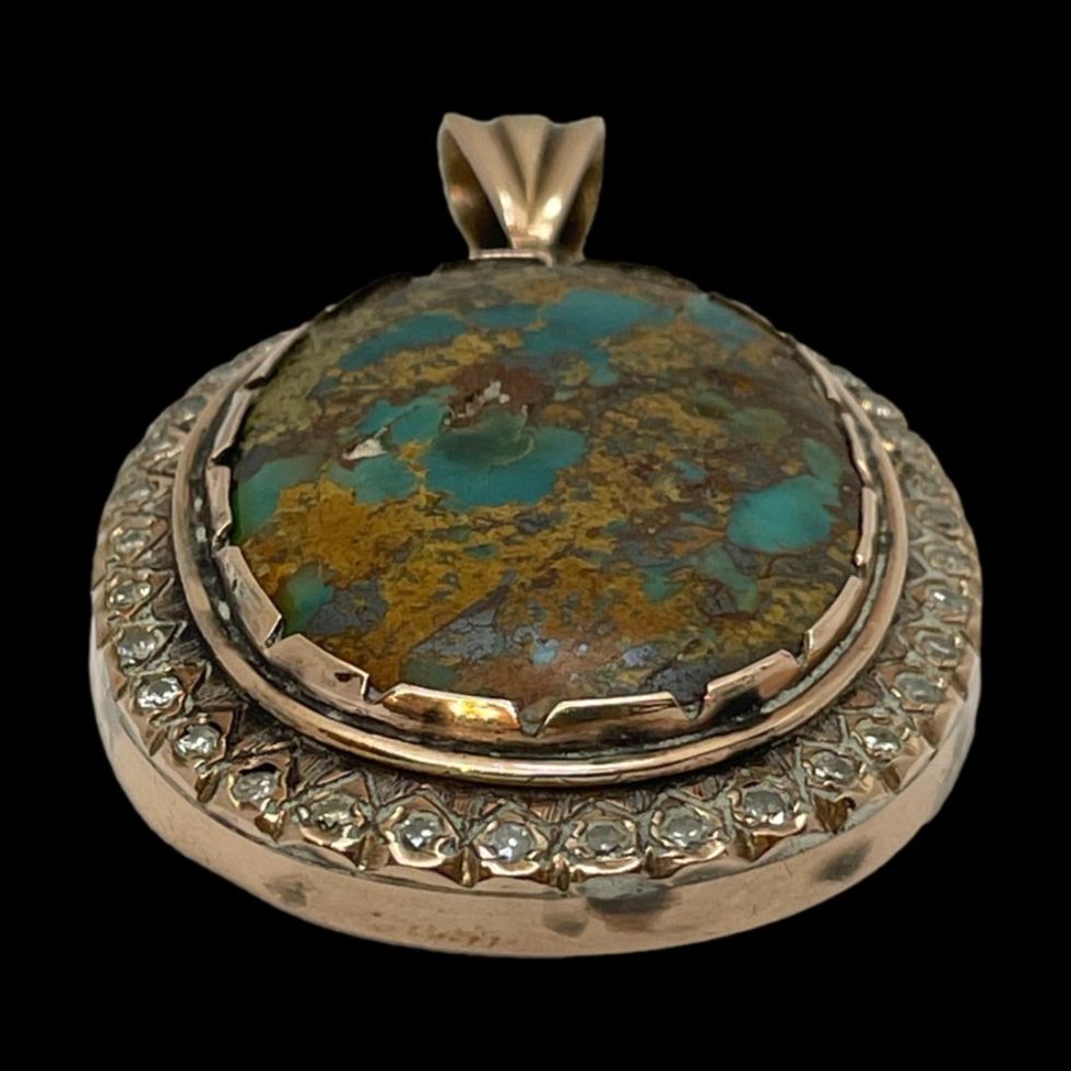 Photo of pendant on a flat surface and seen with the bottom of the pendant in the foreground.