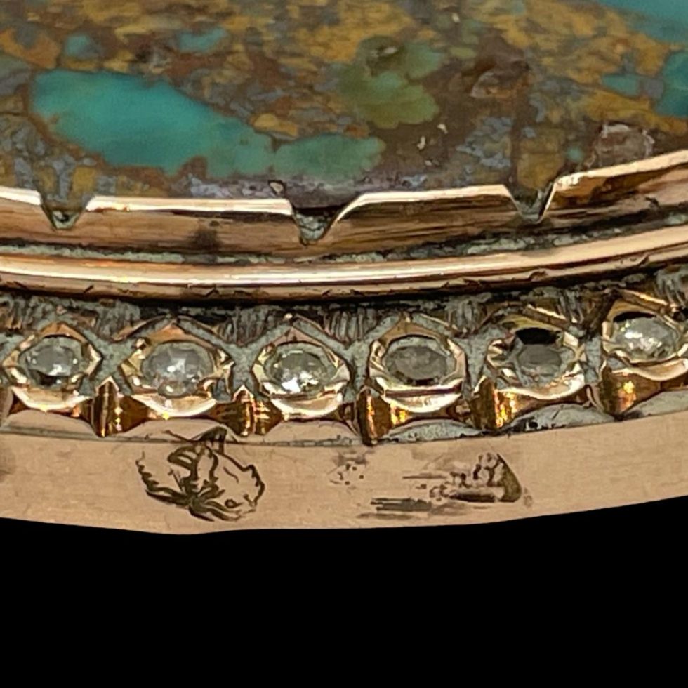 Close up of the hallmark on the opposite side of the outer gold frame.