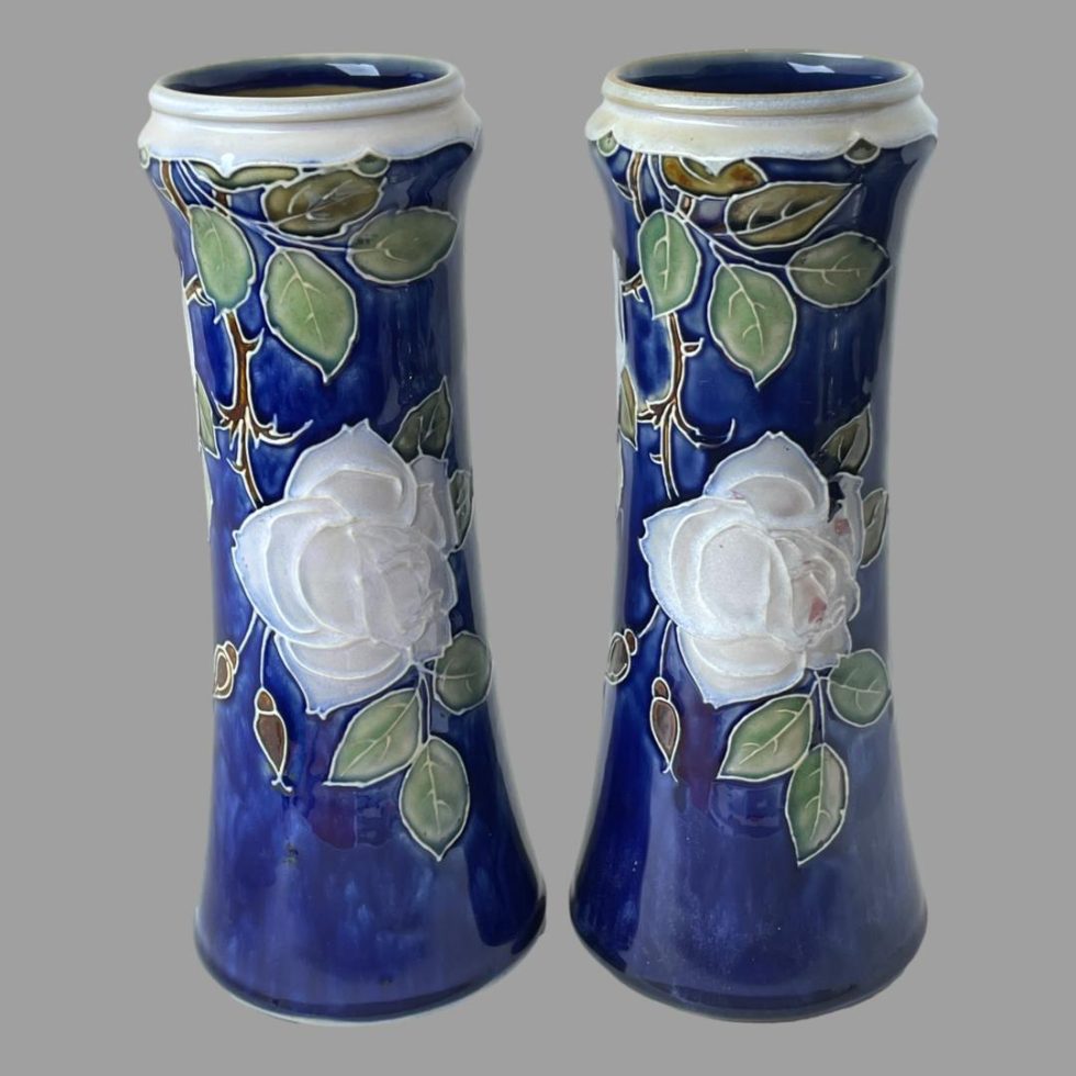 Photo of tall Doulton rose vases this time shown with roses at lower level to both.
