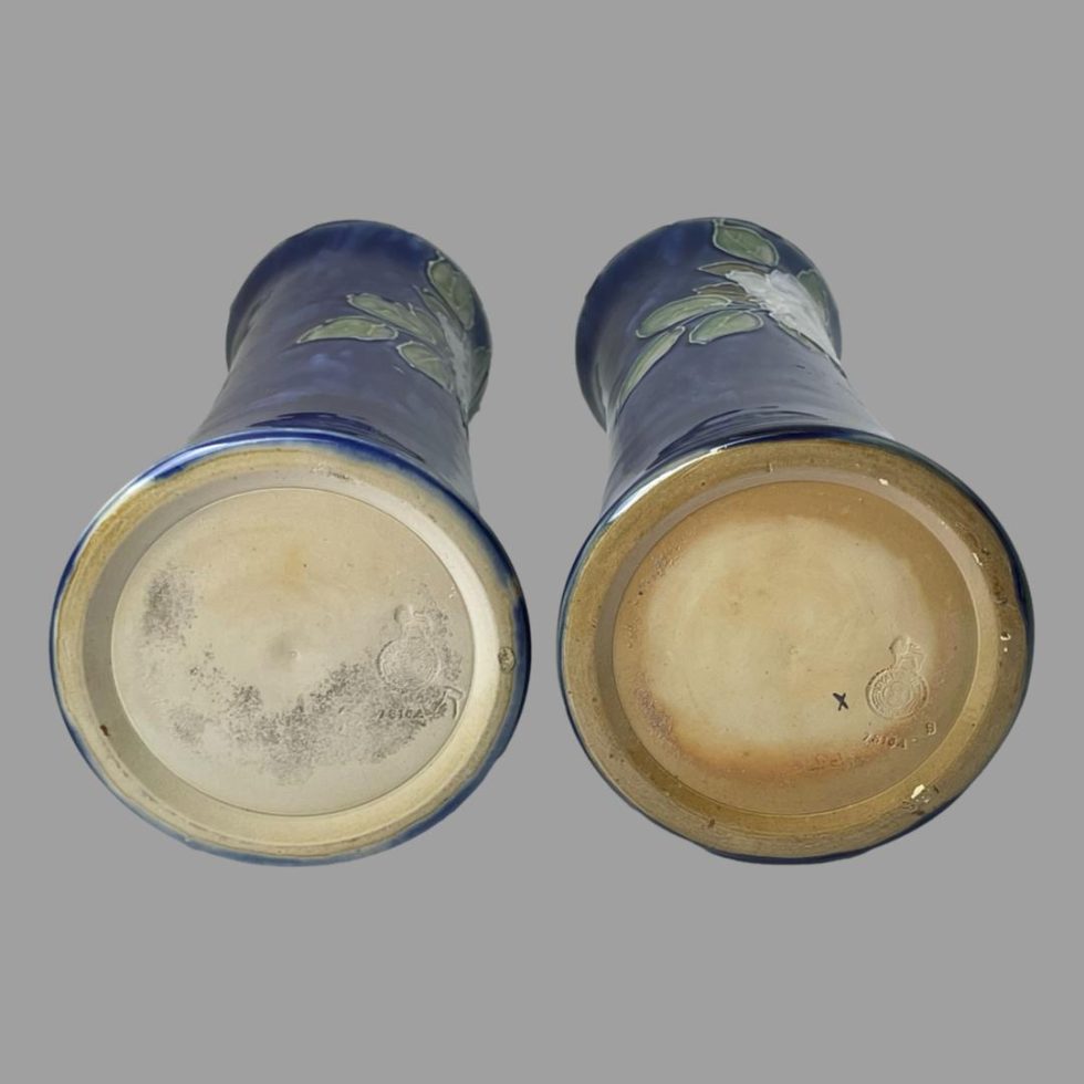 Photo of the base of both tall Doulton rose vases. Colours on the bases are different. Left is cream and right is terracotta round the outside with cream in centre.