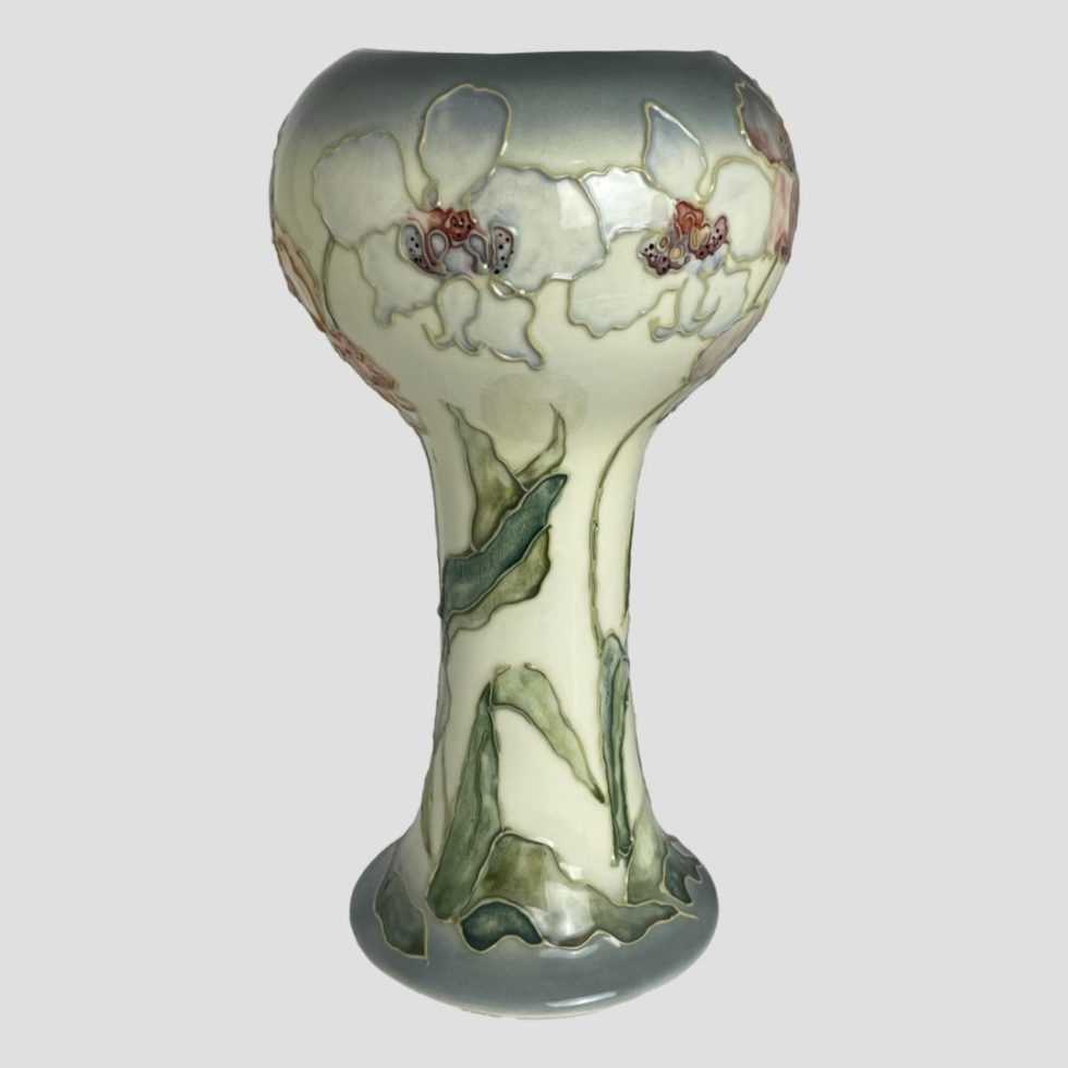 This time photo shows the white orchid flower side of Chris Lucas Studio Pottery vase. Shown from an eye level.