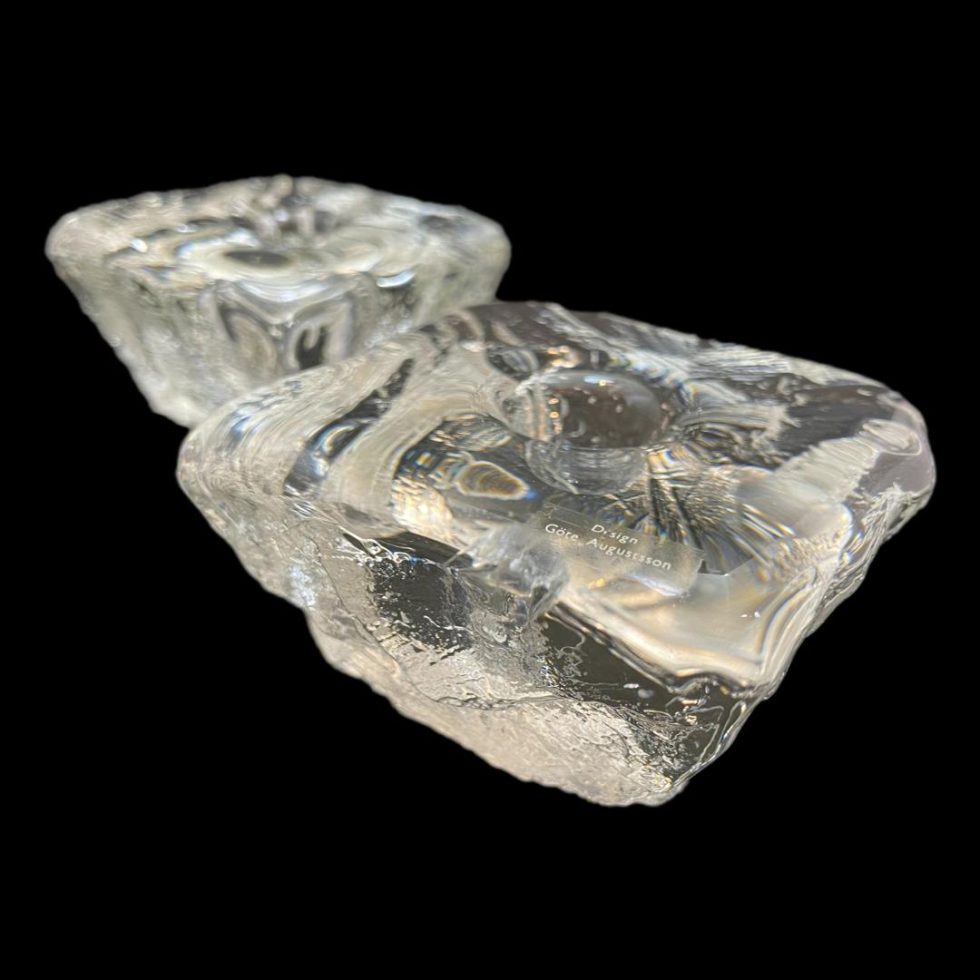 Close up photo of Swedish 'ice' candle holders - one in foreground with one corner in bottom right of photo and other in the background and top left.