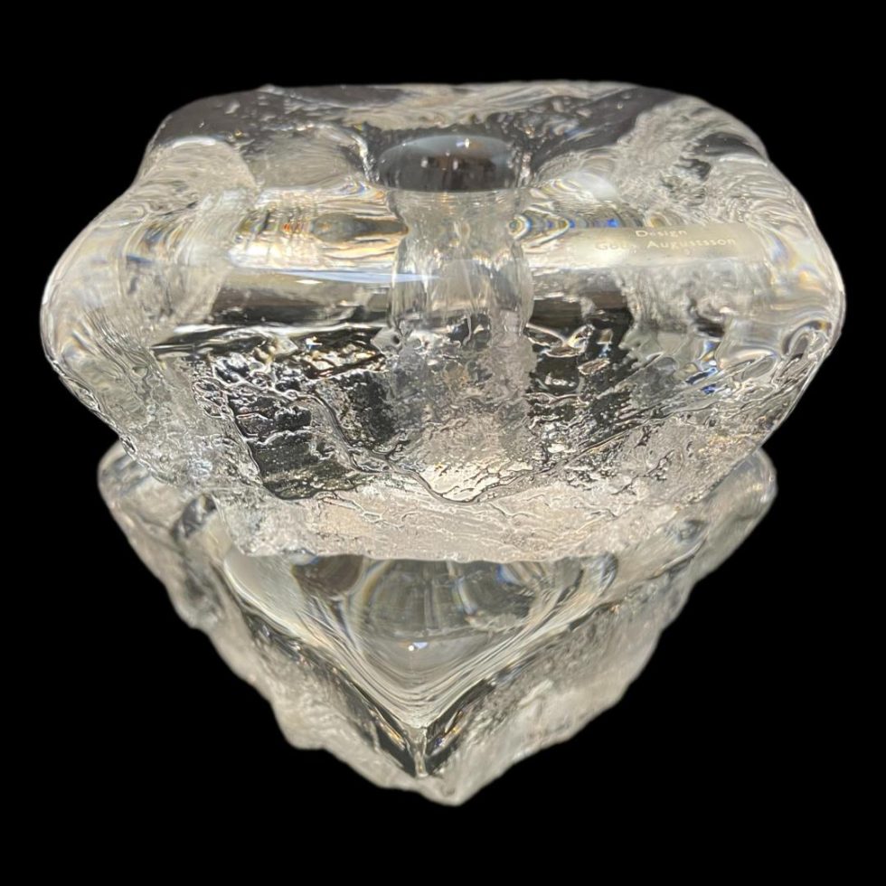 Photo of Swedish 'ice' candle holders with one stacked on top of other. The lower one has a corner protruding in the foreground whilst top one has one side visible.