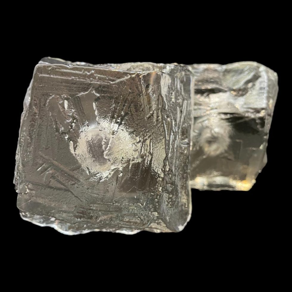 Photo of the bases of both Swedish 'ice' candle holders. You can just make out the gap for the candles through the glass which does uncannily resemble a lump of ice.