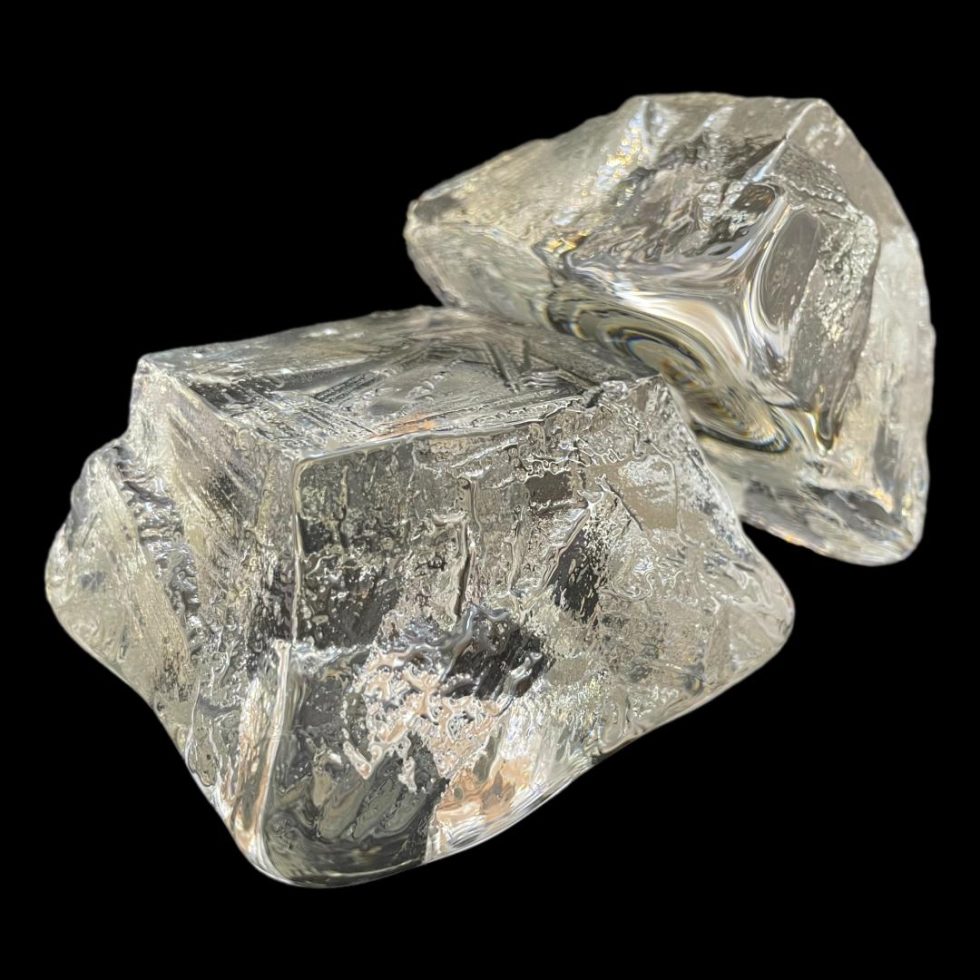 Photo of Swedish 'ice' candle holders displayed top down with one leaning against the other. The lower one has one of its corners in the foreground.