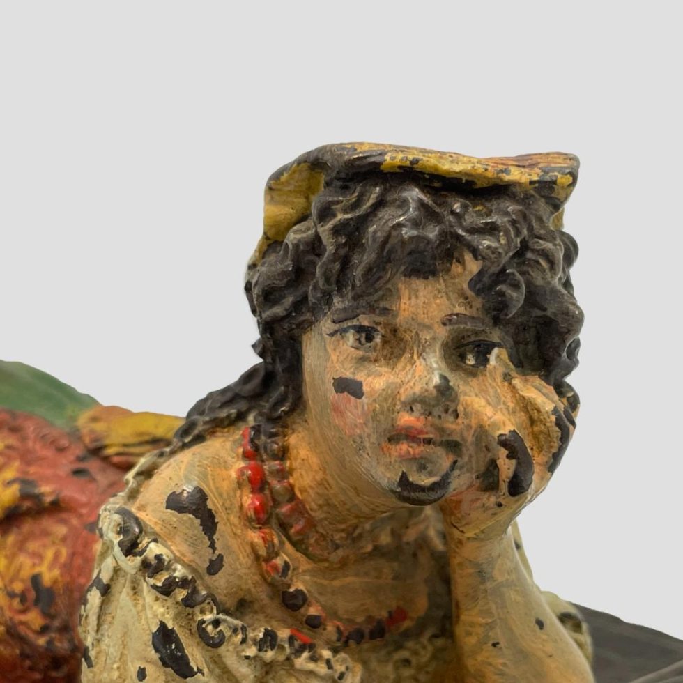 A close up photo of the face area of vintage bronze Bedouin girl with the dreamy look very obvious.