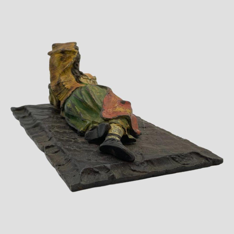 Anoth back angle of vintahe bronze Bedouin girl seen with feet end facing towards the right foreground