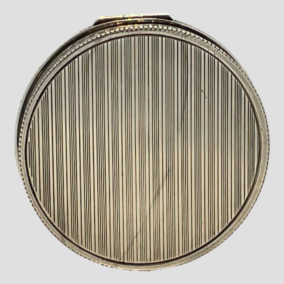 Photo of the engine turned base of the 1930s Austrian silver compact.