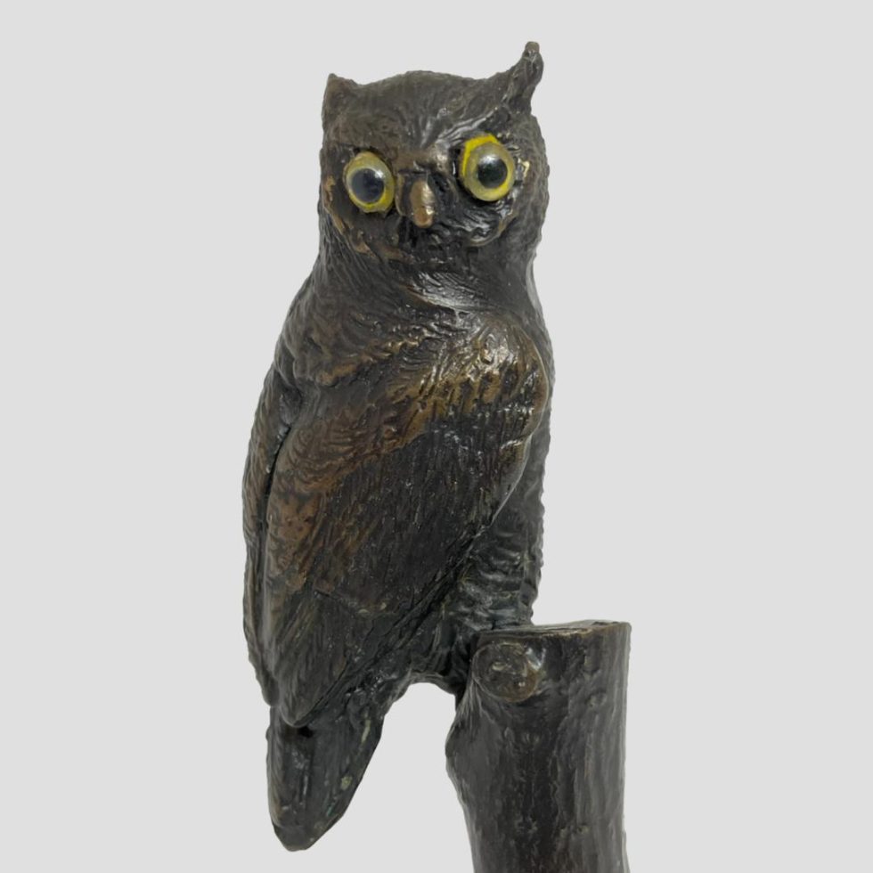 Close up photo of vintage small bronze owl focusing on the owl who is looking straight at you!