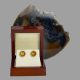 Main photo of carved citrine gold earrings displayed inside their lacquer wood box. There is a slice of natural agate behind the open box.
