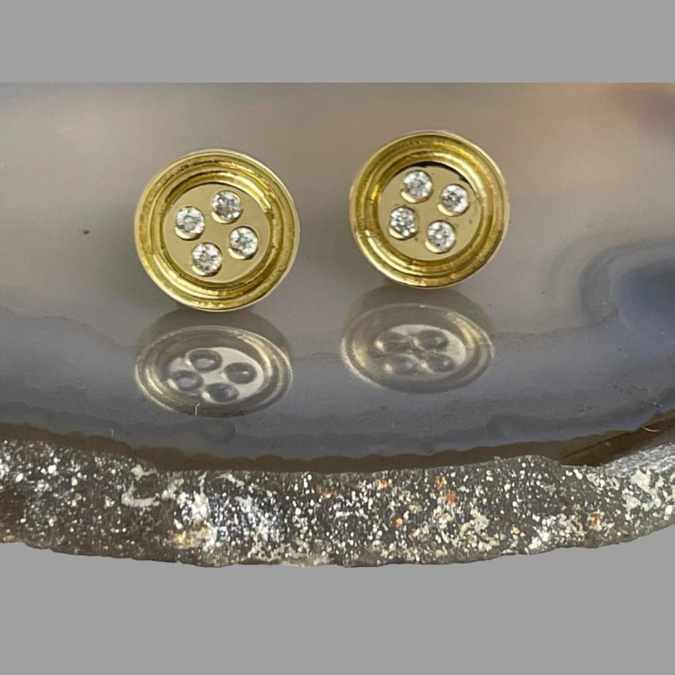 Photo of earrings displayed on a slice of agate and shown forward facing.