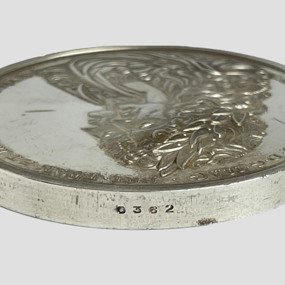 Photo of the numbers 0362 in the top of the reproduction silver commemorative medal.