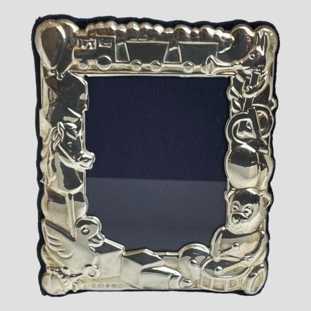 Main photo of toy theme photo frame seen with the front of frame forward facing. The frame is made up of toys from teddy bears, hobby horse, trains amongst others and would be ideal for displaying a child or grandchild's photo. Would be a lovely gift item to give to parents or grandparents with photo included. Hallmark is just visible to bottom left below the rubber duck and building blocks.