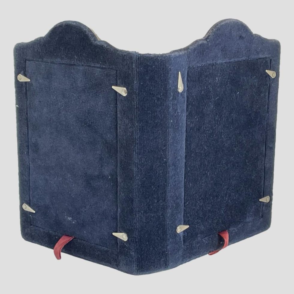 Photo of back of silvcer double photo frame showing the good condition of the blue velvet.