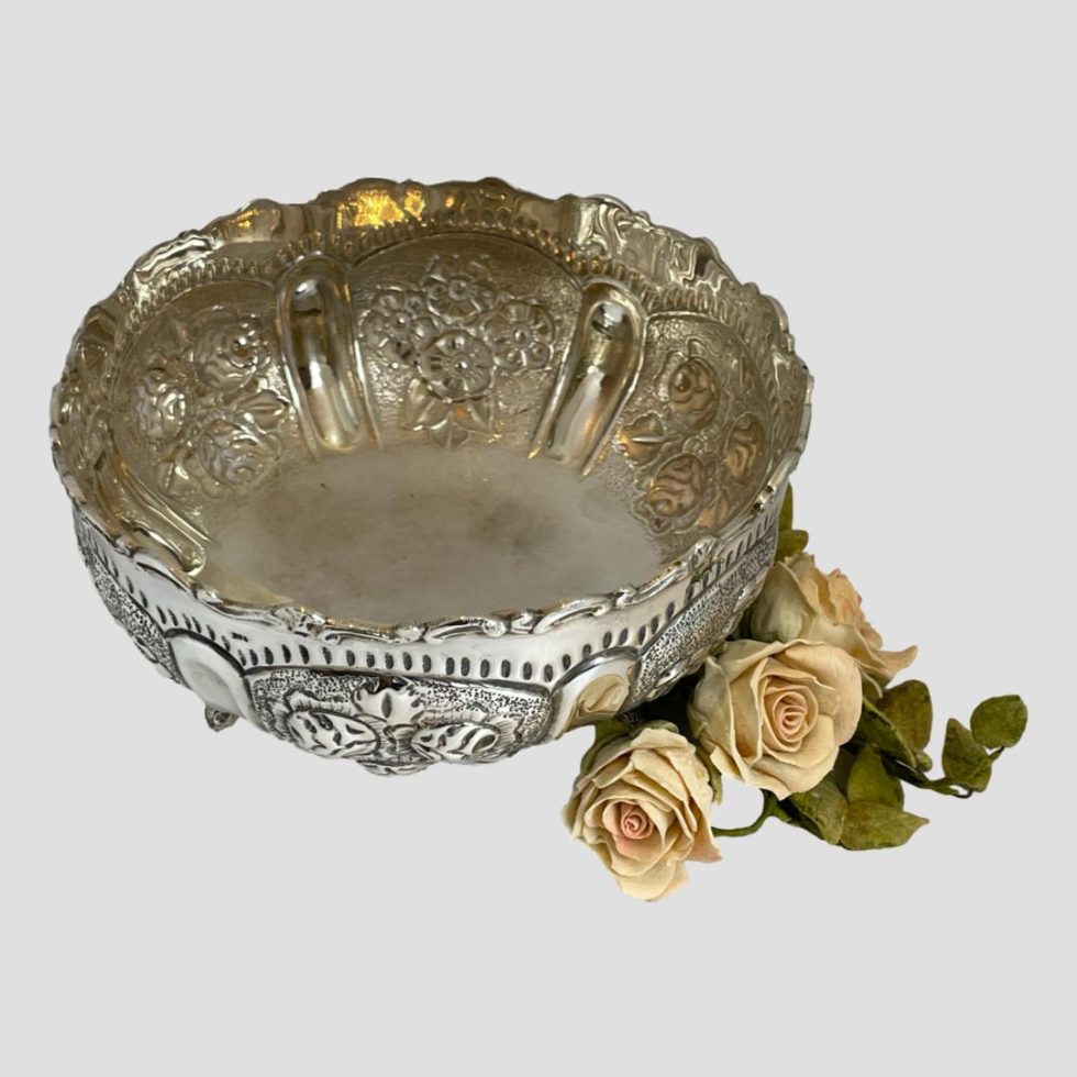 Photo of 835 Continental silver bowl this time seen from a slightly raised angle looking diagonally down into the bowl. The small posy of pink roses is still to the bottom right.