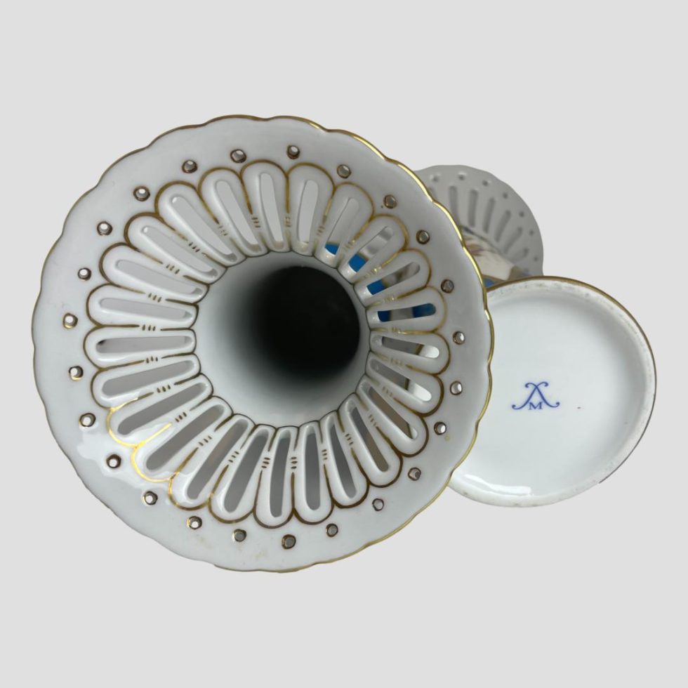 Photo of Sêvres style porcelain vases shown laid flat with left one showing the top of the vase looking at the pierced area and other showing the base with the unidentified makers mark.