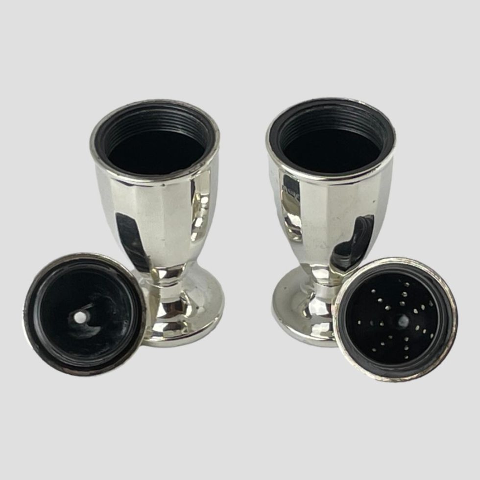 Photo of silver bakelite salt & pepper with their tops removed revealing the bakelite interior. The bakelite lining also extends to inside the tops so they are protected from salt damage. The tops are screw fastening.