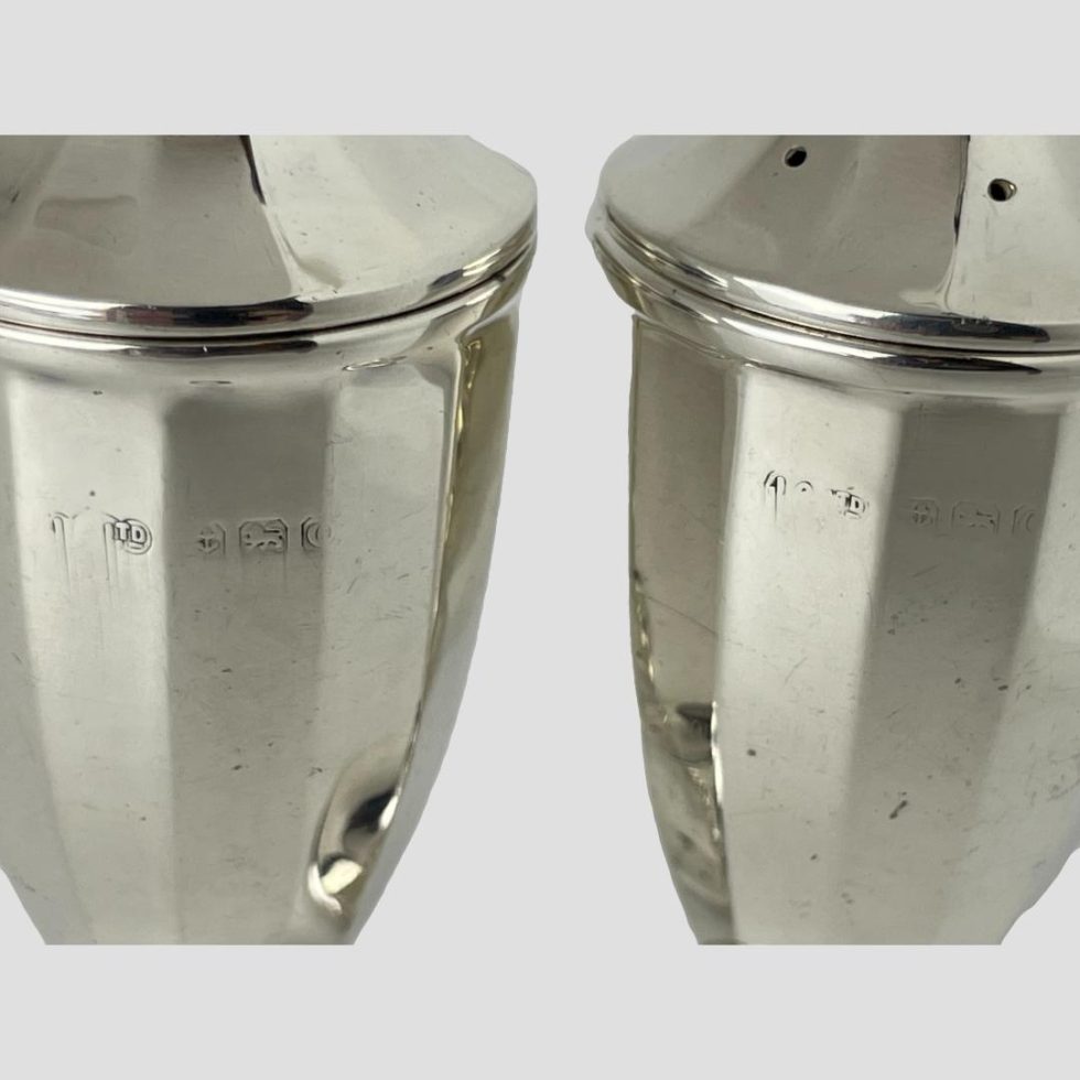 Close up photo of the worn hallmarks on both silver bakelite salt & pepper. Although quite worn it is still possible to make out the details.