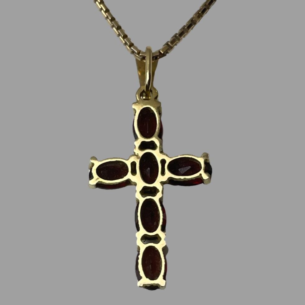 Photo of the back of gold garnet cross & chain showing the back of cross and the back setting for the stones.