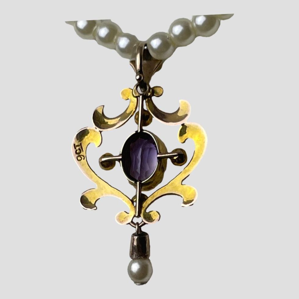 Edwardian gold pendant collar with photo of the back of pendant showing the 9ct hallmark to the left.